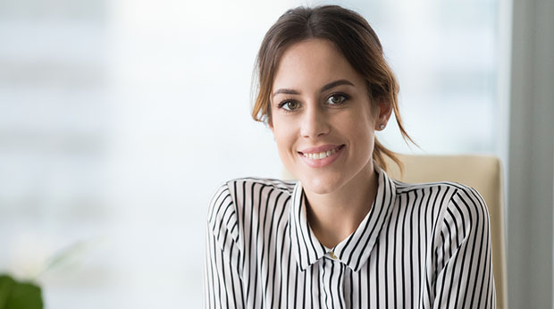 A woman dressed in professional clothing.